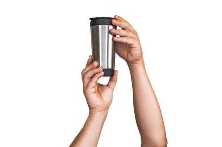 Isolated silver thermos for coffee, tea drink in the hands of a man. On a white backgroundの写真素材