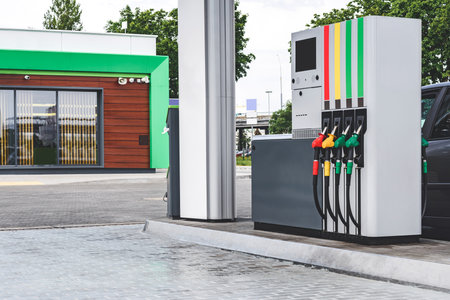 Gas station hoses with gasoline and diesel fuel. against the backdrop of the windowの写真素材