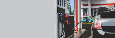 Long Banner, a gas station with a blue gun and petrol and diesel hoses. Against the background of the windowの写真素材