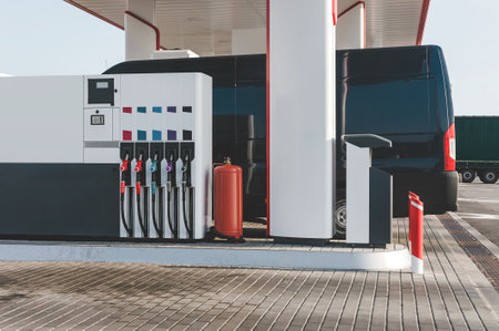 Column with fuel guns in red, yellow and green. at a gas stationの写真素材