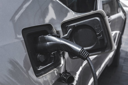 Close-up, power supply for the station, charging electric vehicles. On the background of the carの写真素材