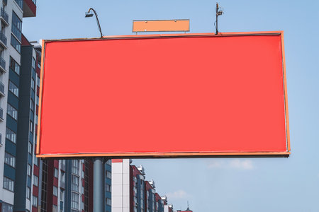 Red bill blankboard mockup. Against the background of a new building of a multi-storey building. Sale and rent of apartmentsの写真素材