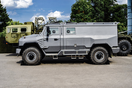 Swat team vehicle or special car gray color, standing in outdoors. Background of sky asphalt and...