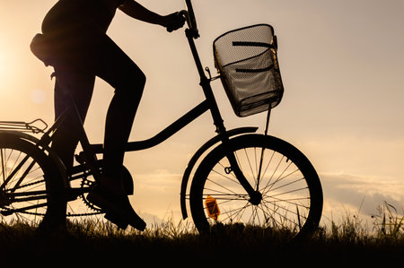 Close-up of a bicycle silhouette with an unrecognizable cyclist. Sunset backgroundの写真素材