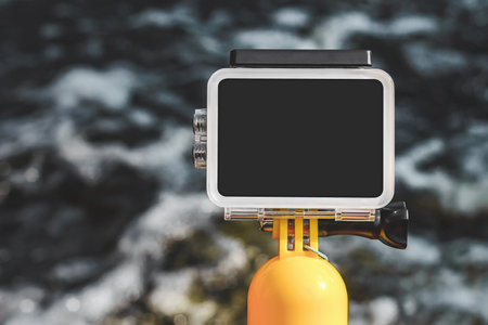 Action camera mockup close-up on the background of water with wavesの写真素材