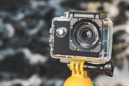 close-up action camera on the background of water with waves in the bokehの写真素材