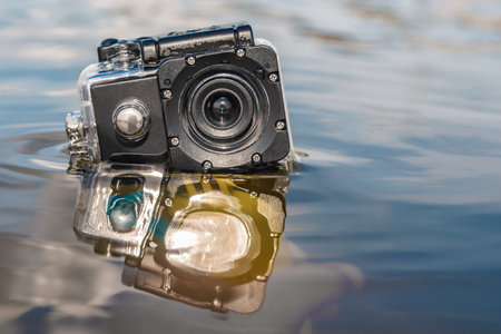 Close-up in the water of a waterproof action camera with reflectionsの写真素材