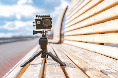 Action Camera stands on a wooden bench. blue sky backgroundの写真素材