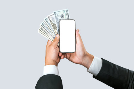 Close-up mockup of a smartphone with American money in the hands of a businessman. on a light gray...