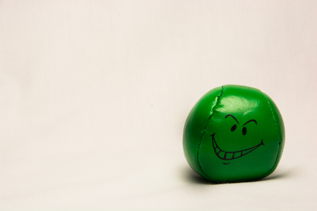 Green Ball with a smiley face isolated on a White backgroundの写真素材