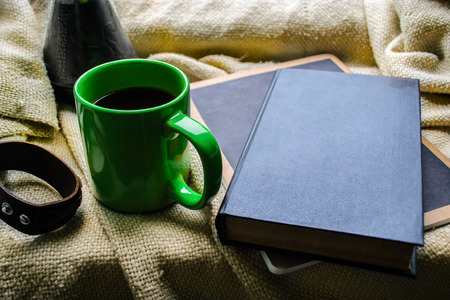 cup of coffee and a book on a windowの写真素材