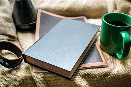 cup of coffee and a book on a windowの写真素材