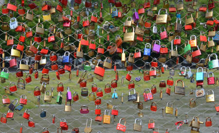 Promises of love with padlocks on the salzach river in the city of Salzburg, Austriaの写真素材