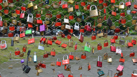 Promises of love with padlocks on the salzach river in the city of Salzburg, Austriaの写真素材