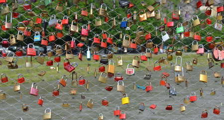 Promises of love with padlocks on the salzach river in the city of Salzburg, Austriaの写真素材