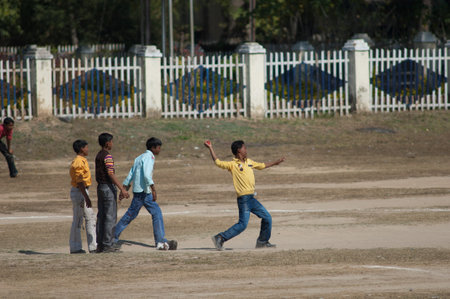Madhya Pradesh, India-January 27, 2010: boys playing criket in the town of Umaria.のeditorial素材