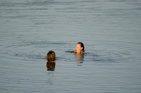 Playa de Arinaga, March 30, 2021: Women bathing in the sea. Aguimes. Gran Canaria. Canary Islands. Spain.のeditorial素材