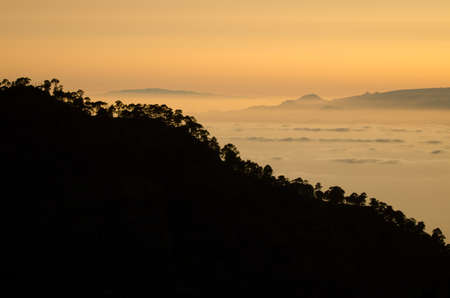 Slope of the Alsandara Mountain in Gran Canaria and south of Tenerife and La Gomera in the background at sunset. Canary Islands. Spain.の写真素材