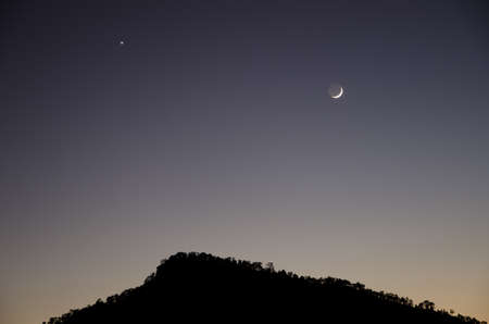 Polar star and waxing crescent moon over Alsandara Mountain. Integral Natural Reserve of Inagua. Tejeda. Gran Canaria. Canary Islands. Spain.の写真素材