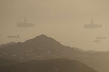 Oil rigs in the northeast coast of Gran Canaria under a dense haze formed by airborne dust. Las Palmas de Gran Canaria. Canary Islands. Spain.の写真素材