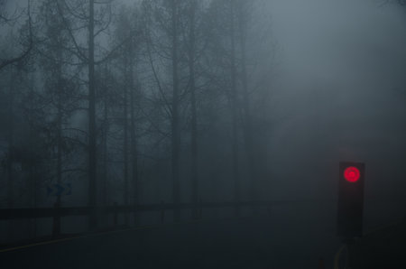 Red no-passing light on a mountain road in fog. San Mateo. Gran Canaria. Canary Islands. Spain.