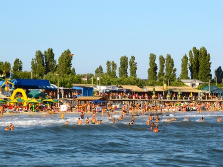 black sea beach in ukraine with people bathing and getting a tanのeditorial素材