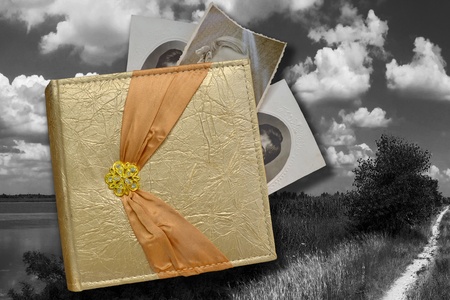a photo-album with old photos over black-and-white photo imageの写真素材