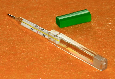 mercury thermometer on a yellow backgroundの写真素材