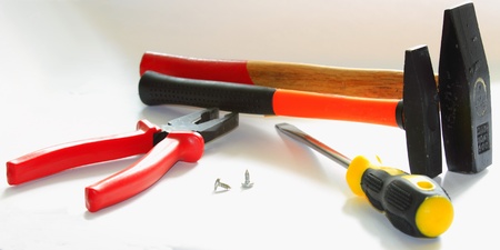 a big hammer with red handle, small hammer with an orange handle, screwdriver with black handle,...