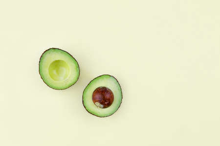 Raw avocado on a light yellow background. High quality photoの写真素材