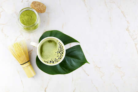 Matcha tea drink. The concept of the Japanese tea ceremony. Green matcha powder and bamboo whisk for making matcha tea.の写真素材