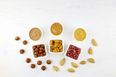 Homemade raw organic peanut, hazelnut, almond paste. Nuts butter in bowls with ingredients.の写真素材