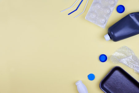 Plastic waste for recycling and reuse on yellow background. Zero waste ecological concept. Top view...
