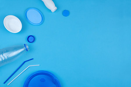 Plastic waste for recycling and reuse on blue background. Zero waste ecological concept. Top view with copy space.の写真素材