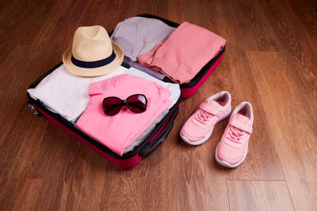 Packing luggage, preparing things for a travel.の写真素材