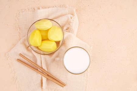 Dairy free potato drink in glass cup. Alternative vegan milk. Copy space, top view.の写真素材