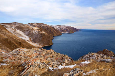 Lake Baikal at the beginning of winter. Aya Bay in December. Open water in the lake, view of the hills and mountain landscape.の写真素材