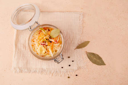 Homemade sauerkraut. Fermented cabbage in a jar on a linen napkin. Vegan food. Top view.の写真素材