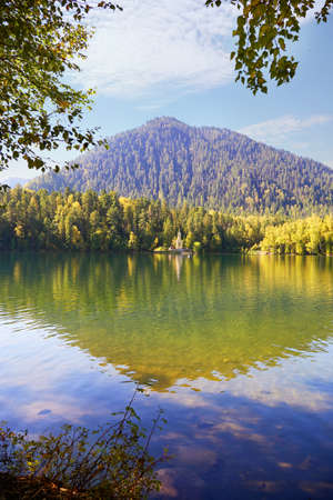 A beautiful autumn landscape. Reflection of the mountain and trees in the lake.