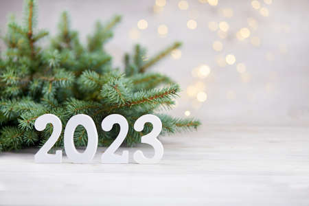 Happy New Year greeting card 2023. Spruce branches, white wooden numbers 2023.の写真素材
