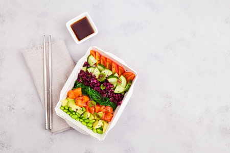 Poke bowl with trout, avocado, vegetables, beans, microgreens and sauce. Hawaiian diet food with...