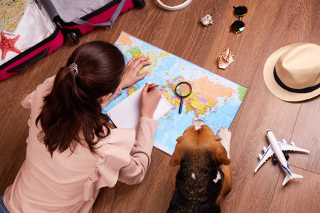 The girl writes a trip plan in a notebook.
