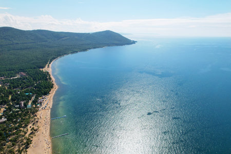 Summer landscape from the air. Sandy beach of the seashore surrounded by coniferous forest.の写真素材