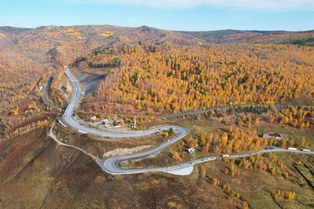 Serpentine road to Lake Baikal. Kultuk village in autumn. Shooting from the air.