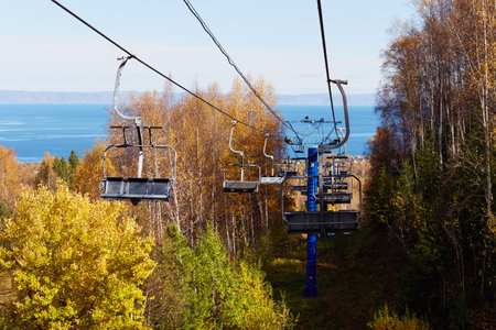 Chairlift to the top of the mountain. beautiful autumn landscape. Ski resort near the lake.の写真素材