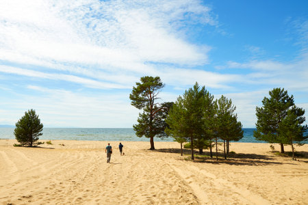 A beautiful summer landscape. A wide sandy beach near Lake Baikal on a sunny summer day. The Republic of Buryatia.の写真素材