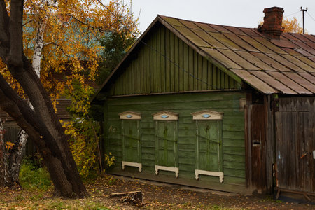 Wooden house with carved shutters and architraves in the historical center of the city. Rustic style.の写真素材