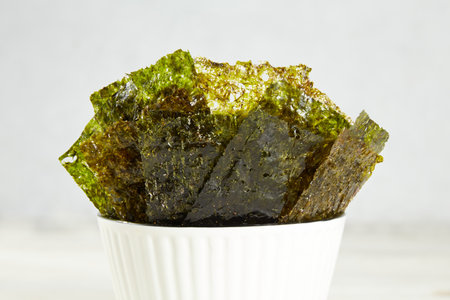 Crispy nori seaweed on bowl. Traditional Japanese dry seaweed sheets. Healthy snackの写真素材