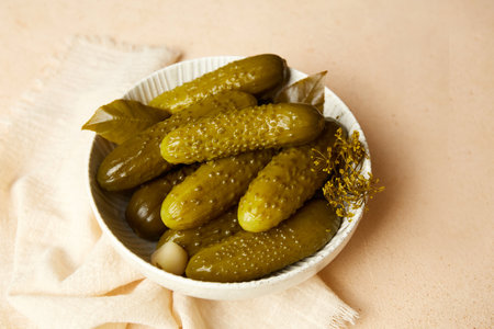 Marinated cucumbers in a bowl on a light background. Homemade pickles. Close-upの写真素材