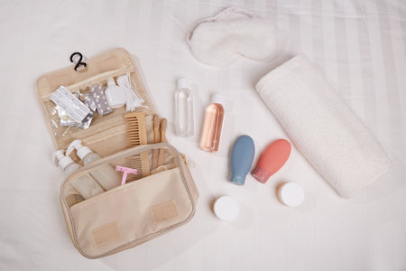 A travel toiletry kit is neatly laid out on a white surface. It includes essential personal hygiene...